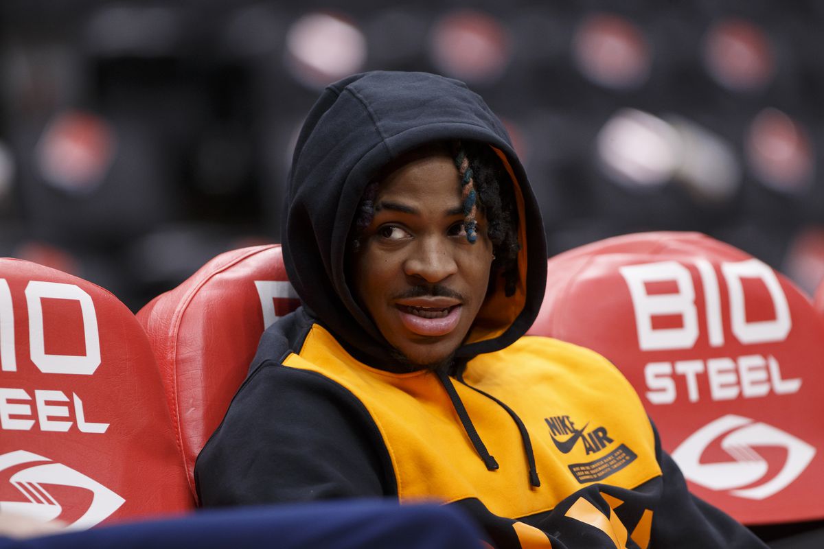 Ja Morant #12 of the Memphis Grizzlies watches as teammates warmup ahead of their NBA game against the Toronto Raptors at Scotiabank Arena on November 30, 2021 in Toronto, Canada.