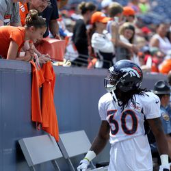 Broncos S David Bruton talks with a young fan 