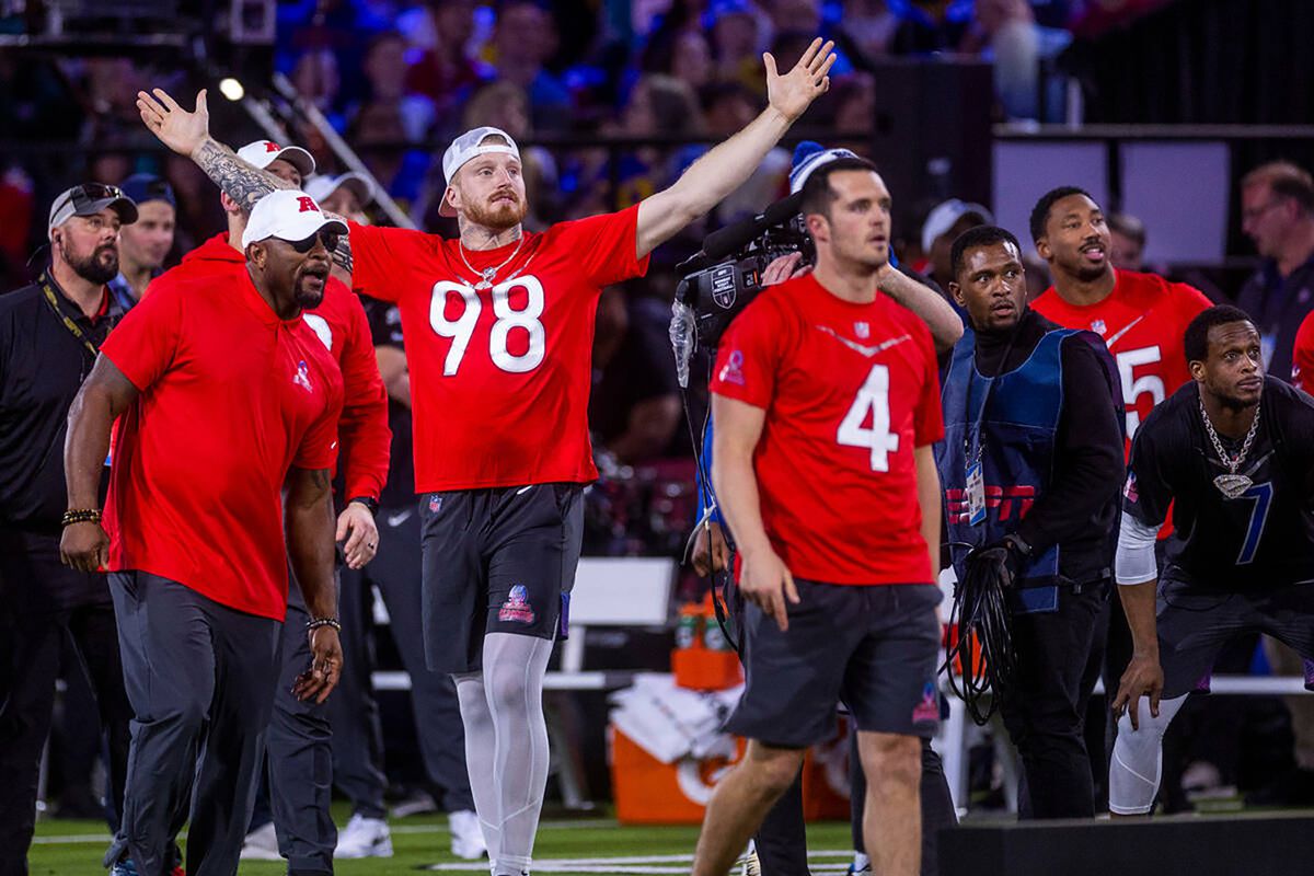 Maxx Crosby (98) of the Las Vegas Raiders is pumped as quarterback Derek Carr (4) watches the flight of a long throw in a precision pass event during the Pro Bowl Games skills competition at the Intermountain Healthcare Performance Center on Feb. 2, 2023, in Henderson, Nevada.