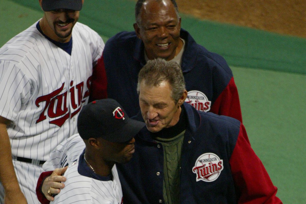 October 8, 2002. Minneapolis, MN. ALCS game #1. Twins vs. Anaheim. At center, former Twin Jim Kaat puts his arm around Jacque Jones after throwing out the first pitch. In back is Eric Milton and Tony Oliva, and in the foreground is Bert Blyleven.