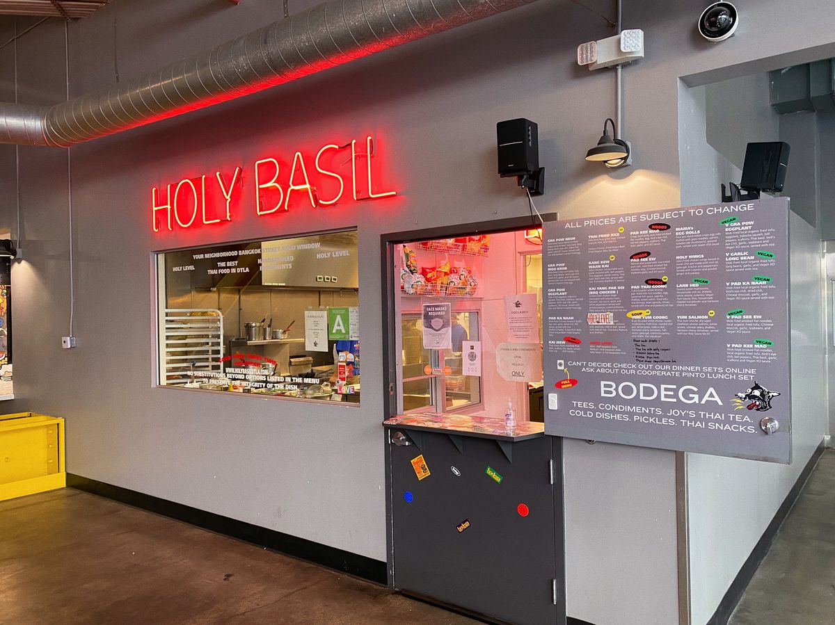 Holy Basil in Downtown LA stall with neon sign and menu board.