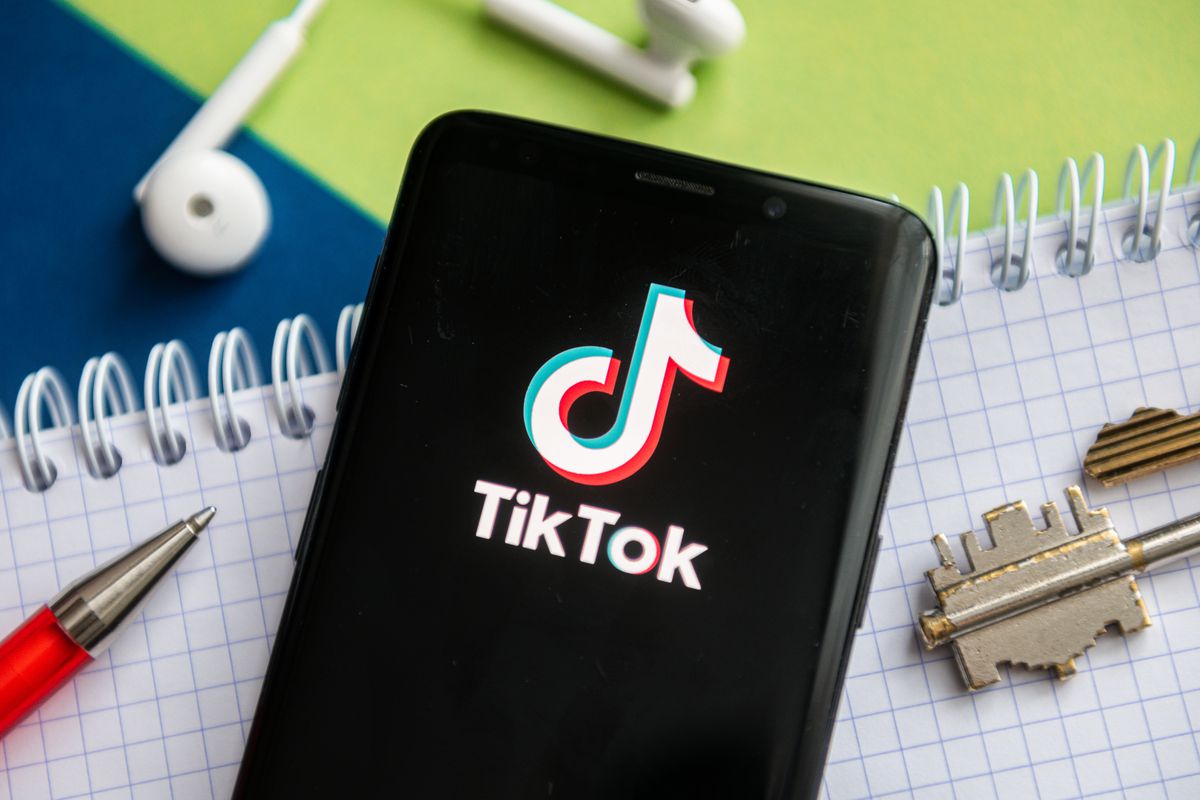 In this photo illustration, a Tik Tok logo seen displayed on...