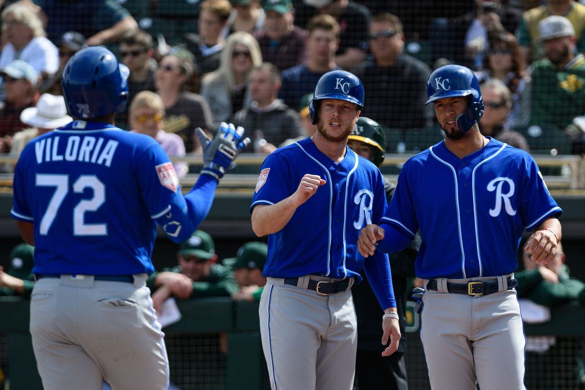 Meibrys Viloria #72 of the Kansas City Royals is congratulated by Brett Phillips #14 and Cheslor Cuthbert #19 after hitting a three run homer in the first inning against the Oakland Athletics at HoHoKam Stadium on February 24, 2019 in Mesa, Arizona.