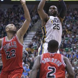 Utah's Al Jefferson puts in a shot over Chicago's Taj Gibson and Nate Robinson as the Jazz and the Bulls play Friday, Feb. 8, 2013 at Energy Solutions arena. Chicago won 93-89.