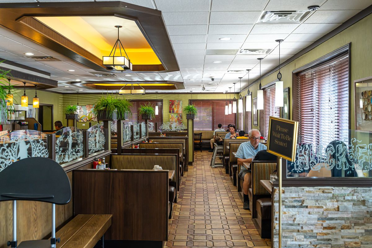 A dining room filled with booths inside a diner.