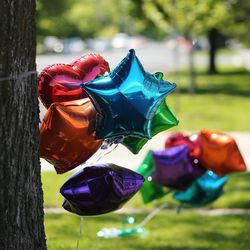 Balloons tied to a tree in honor of Elizabeth "Lizzy" Shelley are pictured during her funeral in Logan on Tuesday, June 4, 2019. Lizzy was abducted from her Logan home and found dead five days later.