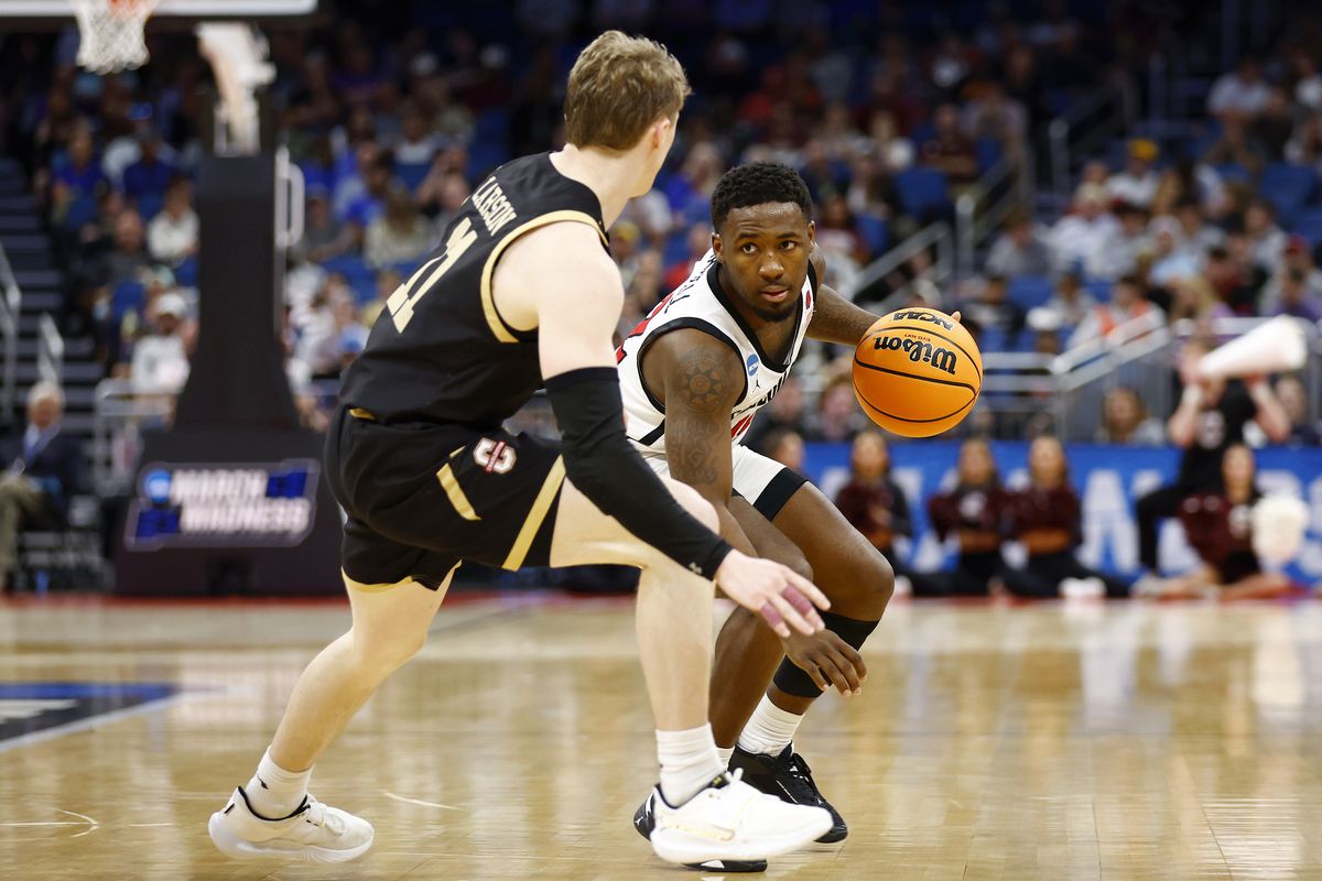 Darrion Trammell #12 of the San Diego State Aztecs dribbles the ball against Ryan Larson #11 of the Charleston Cougars during the second half in the first round of the NCAA Men’s Basketball Tournament at Amway Center on March 16, 2023 in Orlando, Florida.