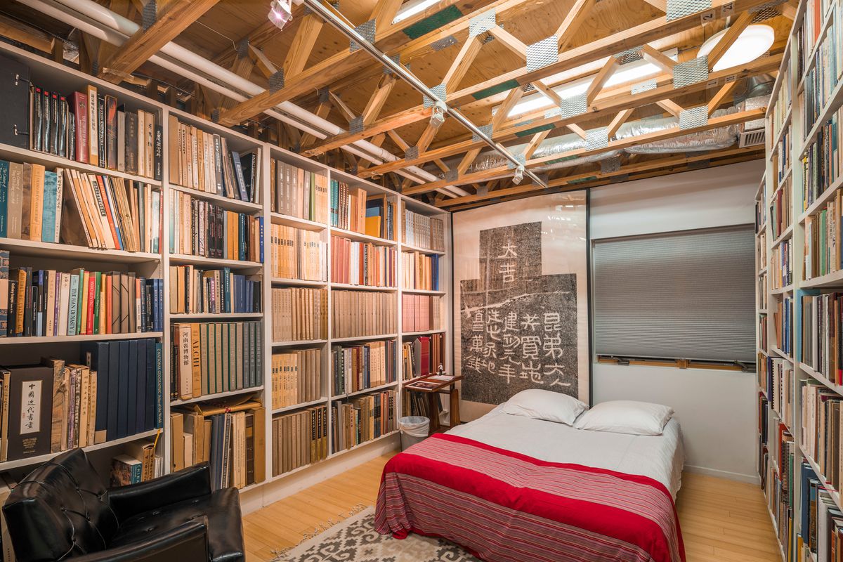 Bedroom with tall bookshelves