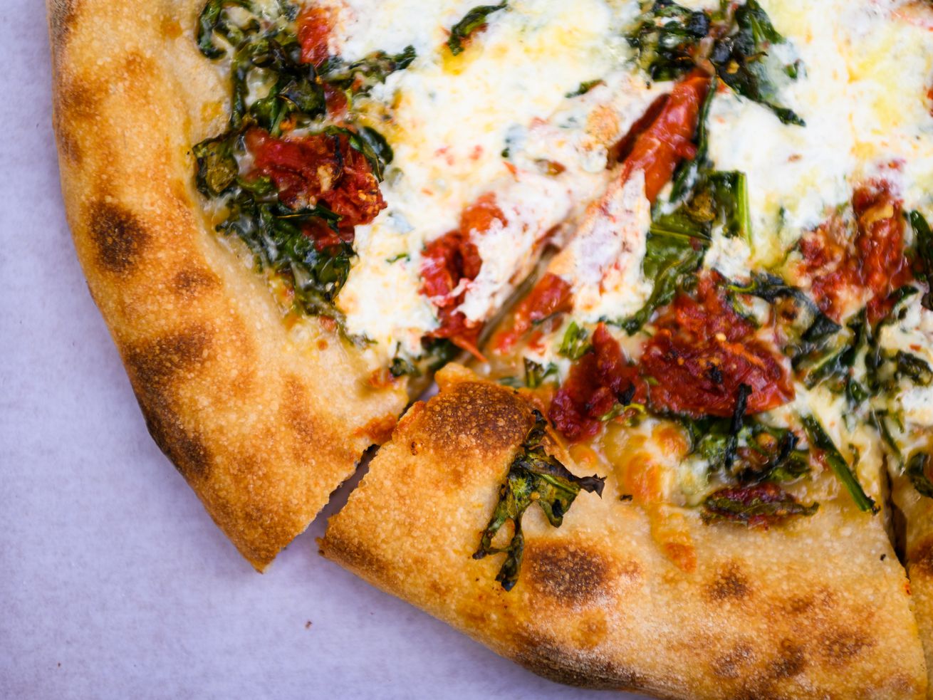 A pizza covered in kale and sundried tomatoes at Lovely’s Fifty Fifty