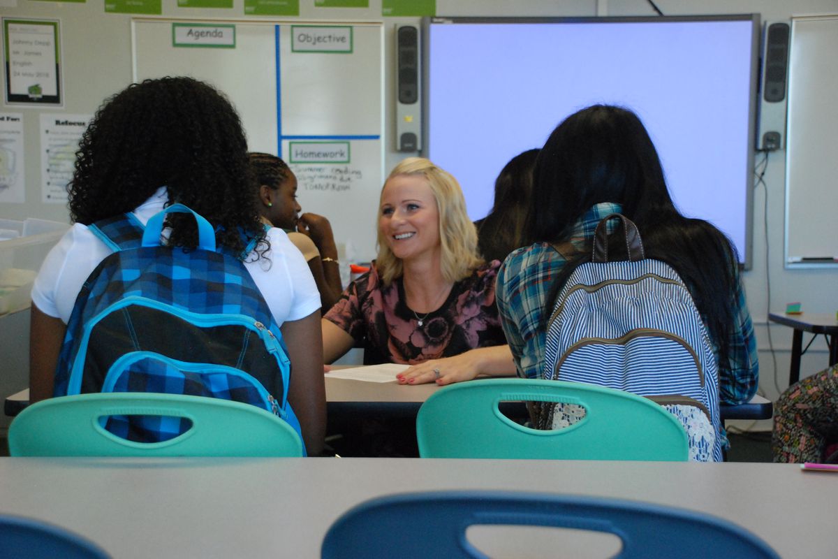 A teacher at DSST Cole High in Denver greets her students on the first day of class in 2014.
