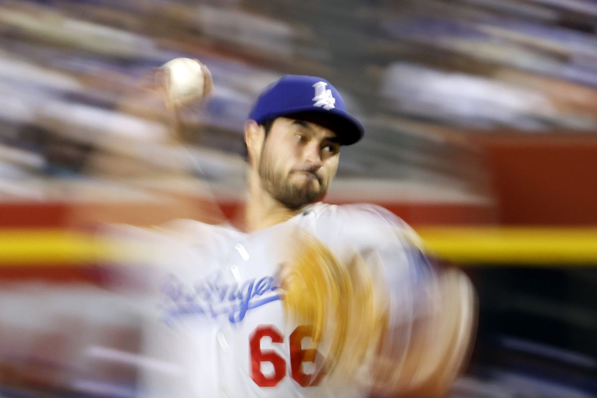 Super cool long exposure shot of a dodger pitcher throwing a pitch, making his arms and the background extremely blurry