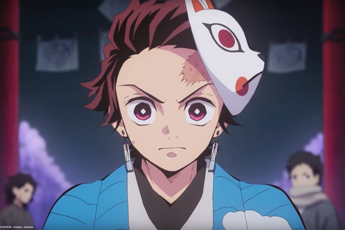 Tanjiro from Demon Slayer looks into forward with a mask on his head