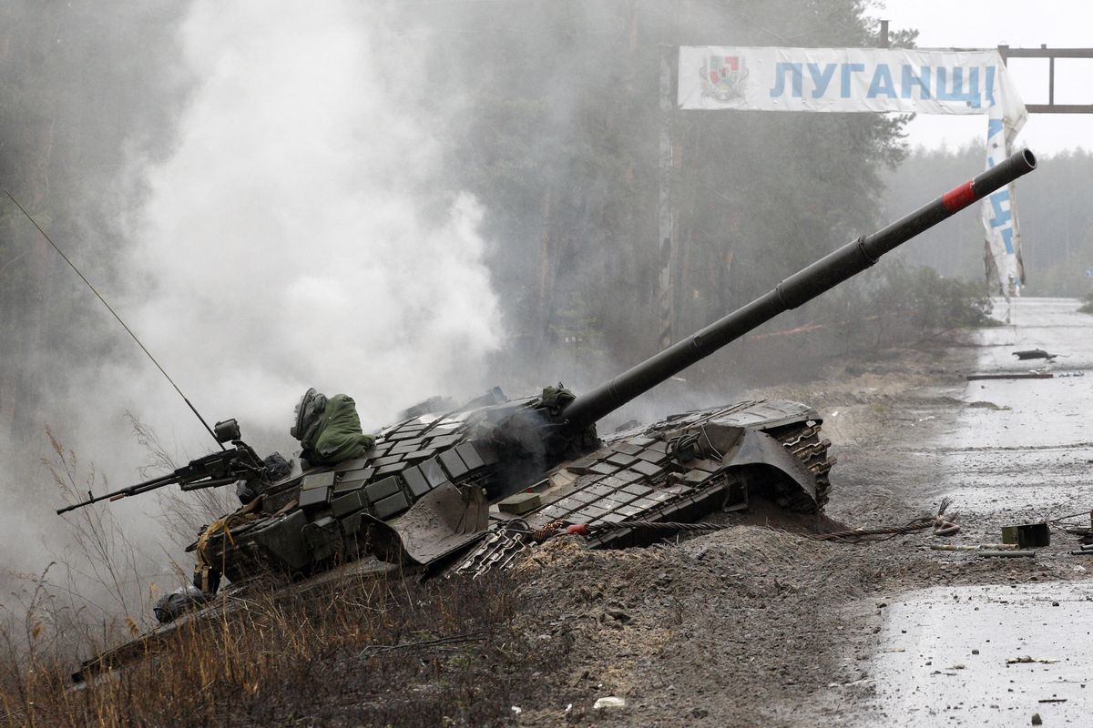 Smoke rises from a destroyed Russian tank on the side of a road in the Luhansk region of Ukraine on February 26, 2022.