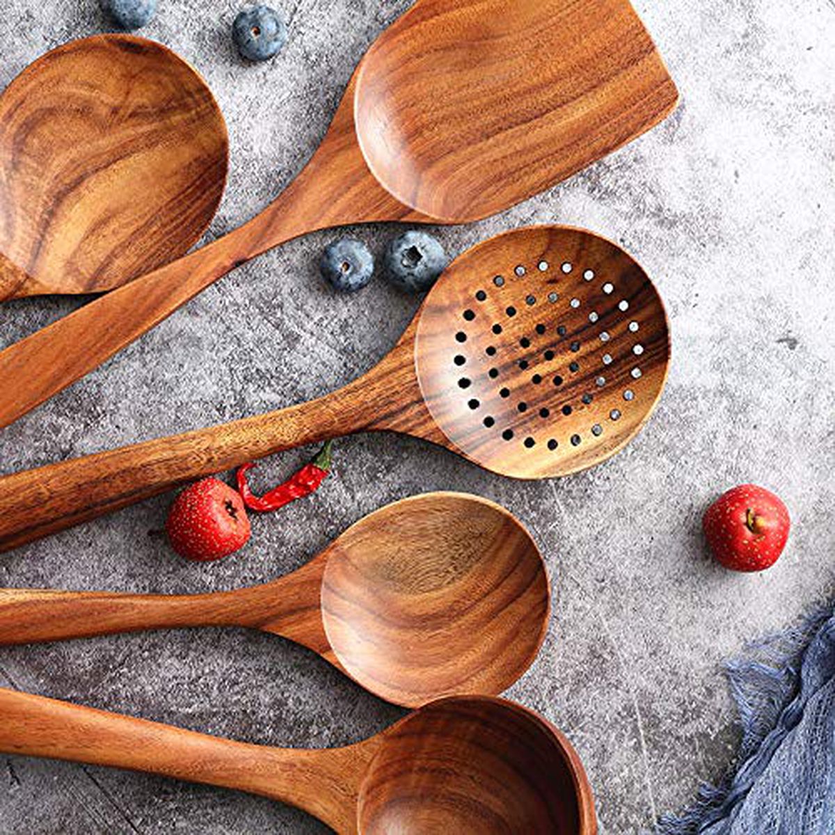 Wooden kitchen utensils on a gray surface.