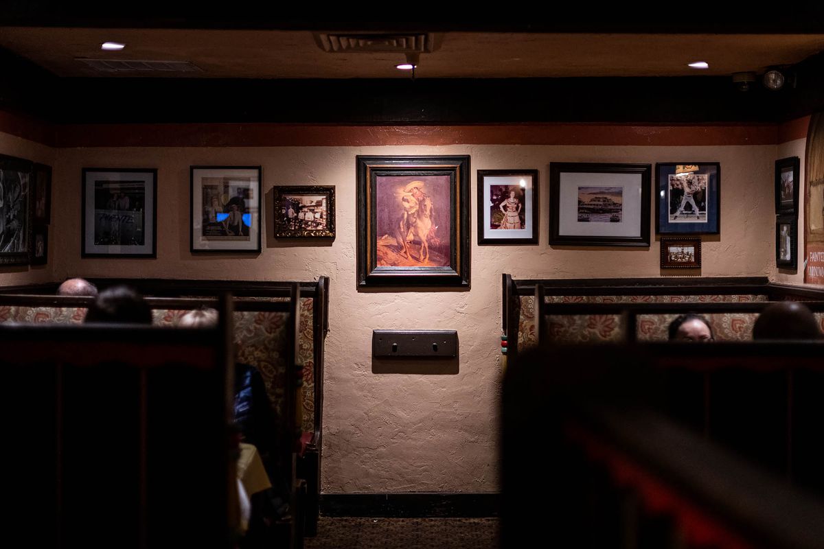 Framed photos in a dining room at El Cholo restaurant in Los Angeles.
