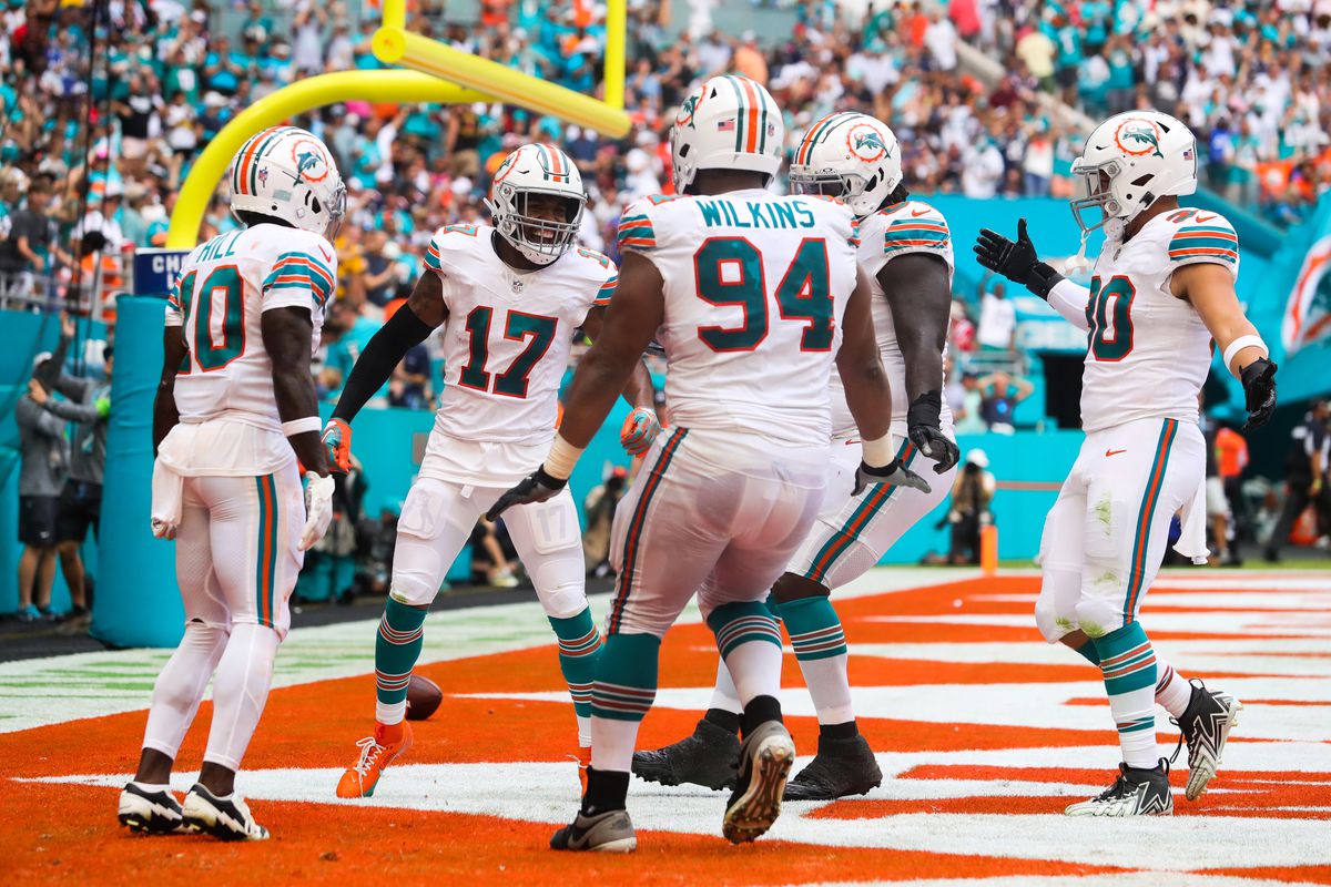 Jaylen Waddle #17 of the Miami Dolphins celebrates with teammates after his receiving touchdown during the fourth quarter against the New England Patriots at Hard Rock Stadium on October 29, 2023 in Miami Gardens, Florida.