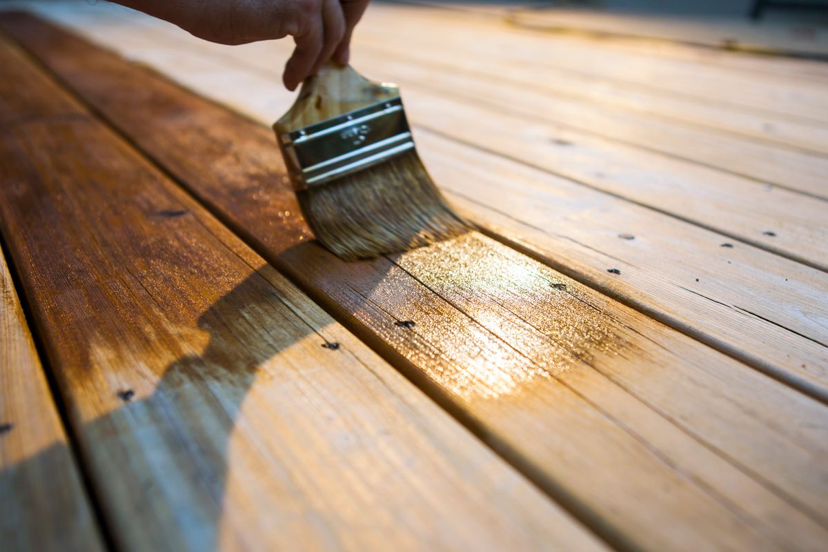 Sealing a clean deck with a paintbrush