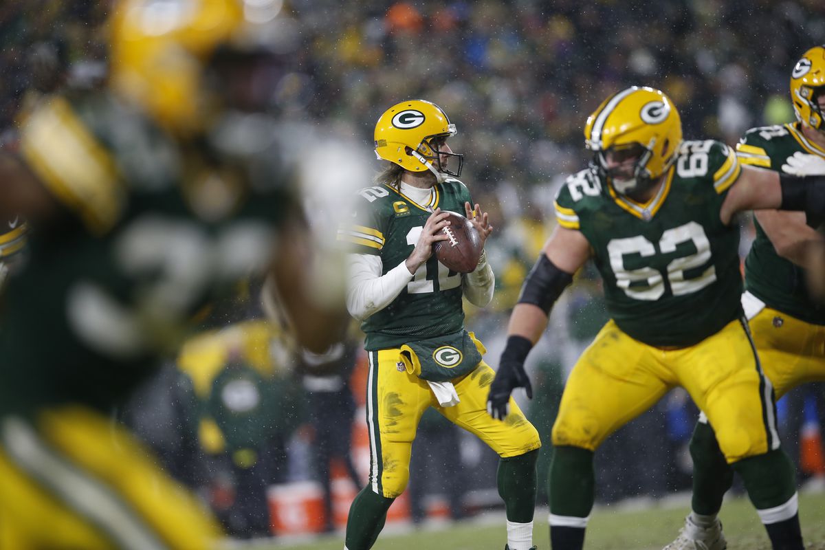 Aaron Rodgers #12 of the Green Bay Packers looks for a receiver during the game against the San Francisco 49ers in the NFC Divisional Playoff game at Lambeau Field on January 22, 2022 in Green Bay, Wisconsin. The 49ers defeated the Packers 13-10.