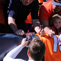 Broncos kicker Matt Prater stops to sign autographs before suiting up at the Summer Scrimmage