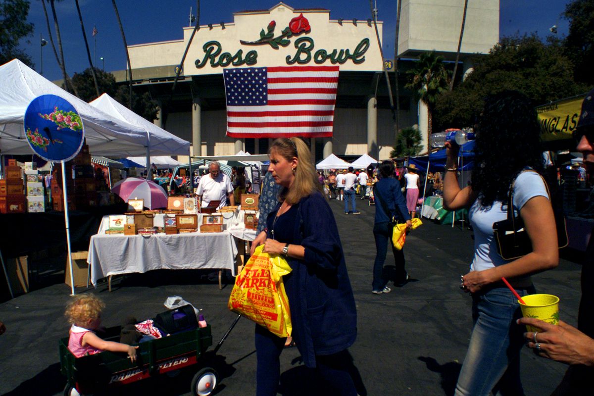 Shoppers wade through booths at the the Rose Bowl Flea Market, Sunday afternoon in Pasadena. Flea Ma