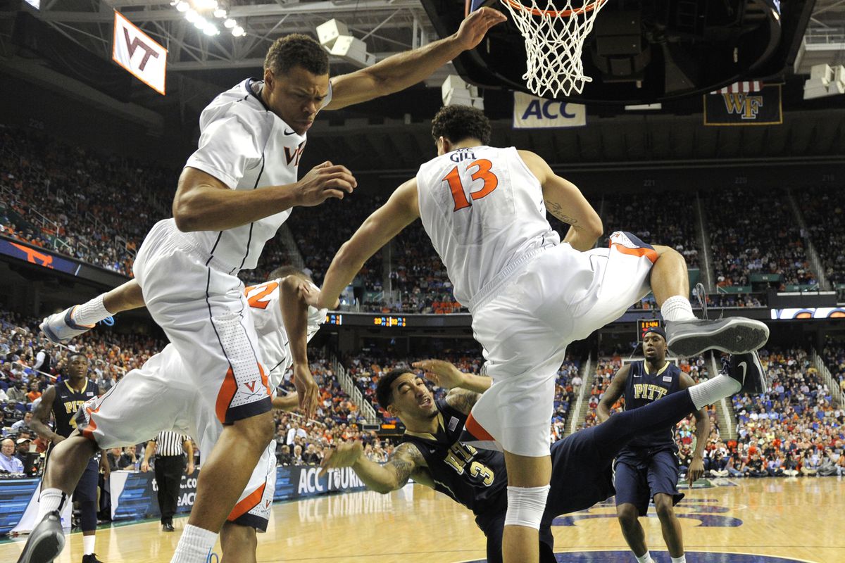 Mar 15, 2014; Greensboro, NC, USA; Pittsburgh Panthers guard Cameron Wright (3) shoots as Virginia Cavaliers guard Justin Anderson (1) and forward Darion Atkins (32) and forward Anthony Gill (13) defend in the second half in the semifinals of the ACC