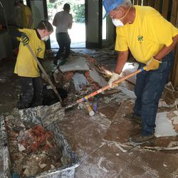 Jeremy Brough, 12, of Zachary, Louisiana, and Severia Baunchand of Baker, Louisiana, muck out the Brown home in Lumberton, Texas, on Saturday, Sept. 9, 2017.