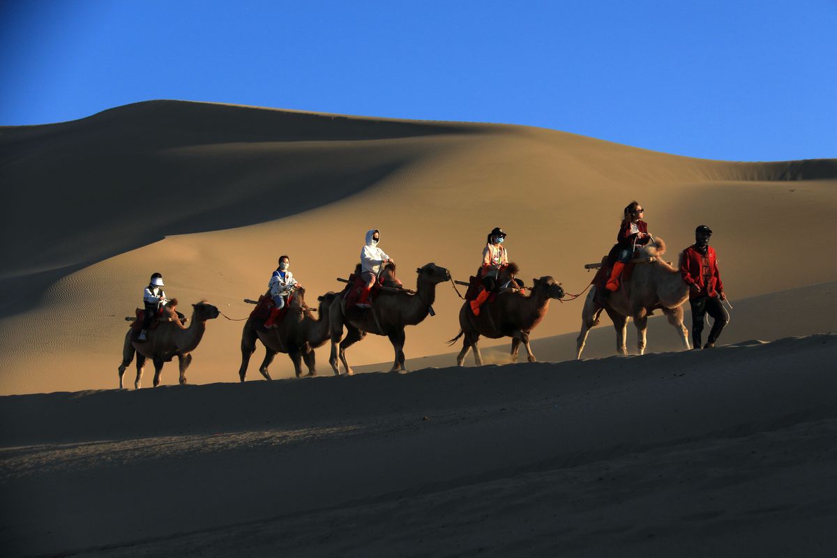 Tourists Visit Mingsha Mountain And Crescent Spring Scenic Spot In Dunhuang