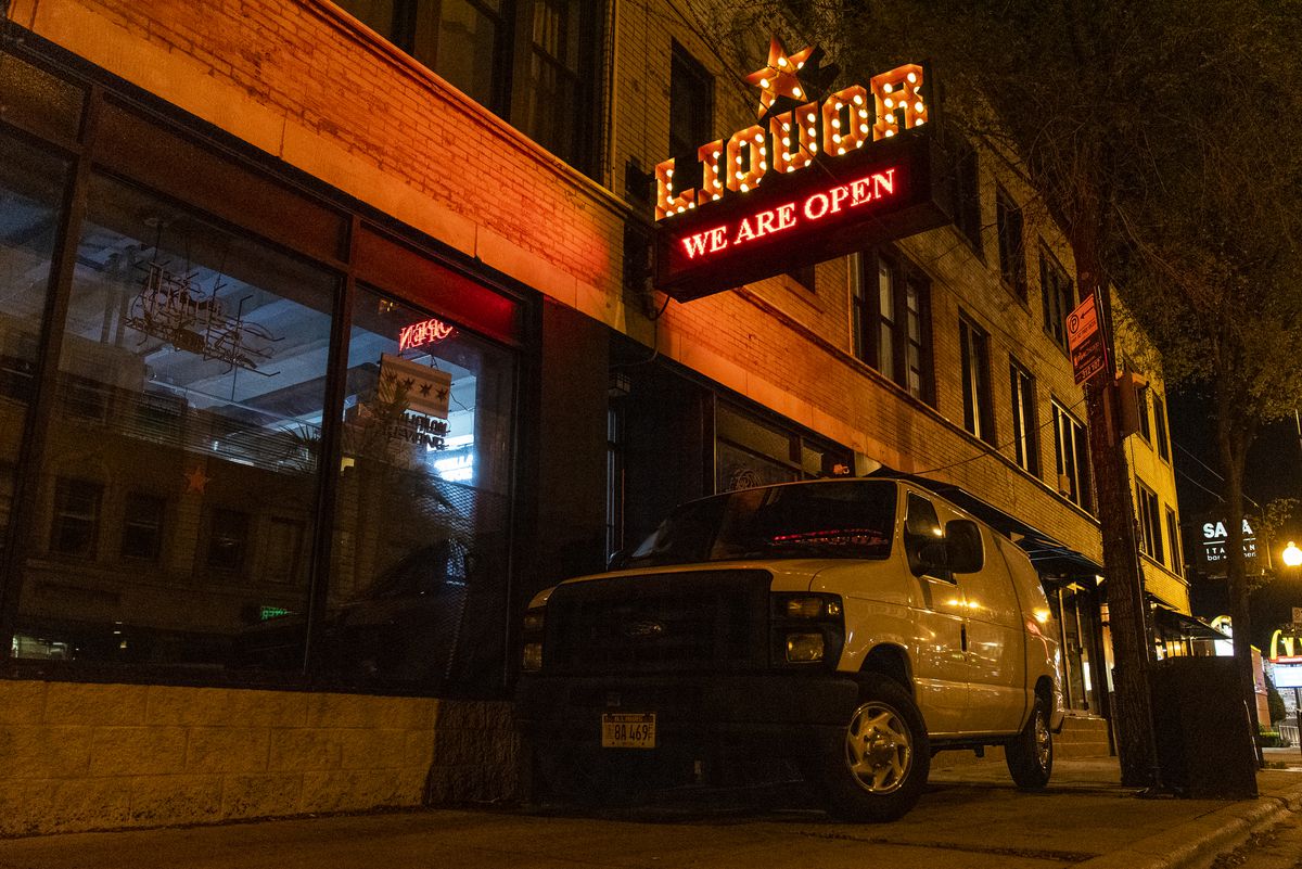 A white van parked in front of Red Star Liquor to protect it from looting in the Logan Square neighborhood, Sunday night, May 31, 2020. Owner Esam Hani parked the van there to prevent looting and is also hanging out on the block with friends and family to keep watch on the businesses.