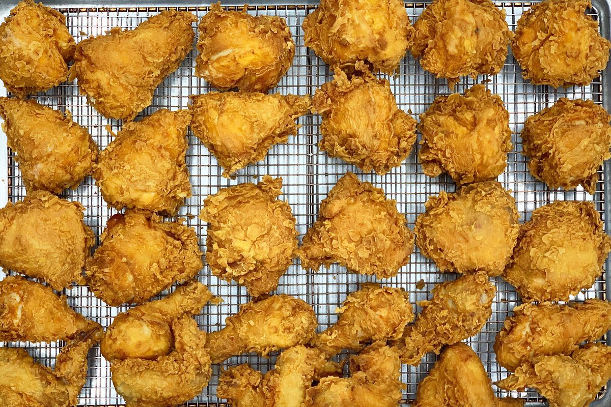 A wire tray of fried chicken pieces from above