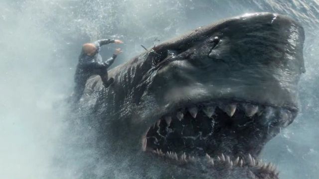 Jonas Taylor (Jason Statham) stabbing a megalodon shark in the eye with a spear in The Meg.
