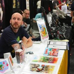 Derek Hunter interacts with fans at his Salt Lake Comic Con booth. Despite having the name Comic Con, the convention showcases a variety of artists and guests outside of the comic book genre.