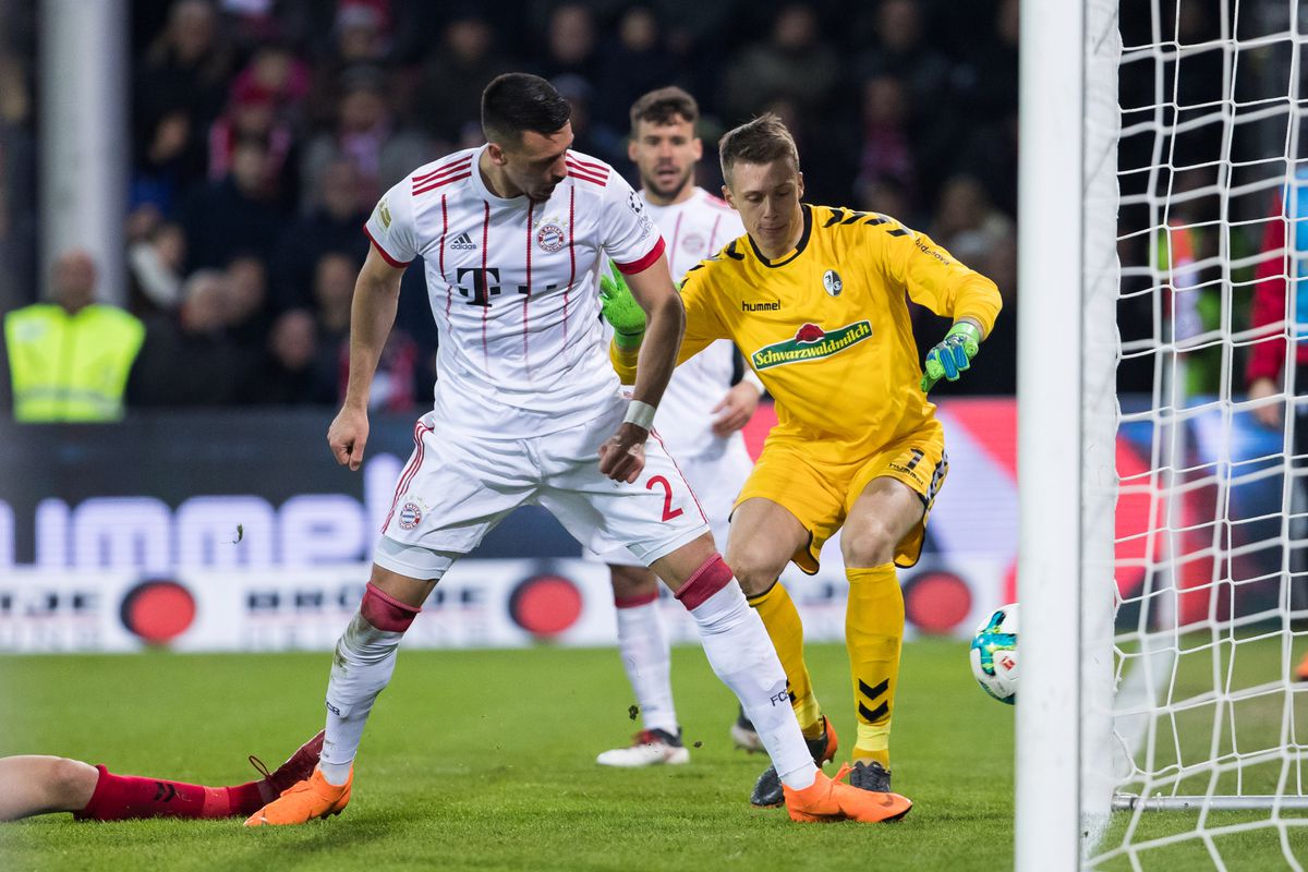 Sandro Wagner of Muenchen scores his side's third goal past goalkeeper Alexander Schwolow of Freiburg during the Bundesliga match between Sport-Club Freiburg and FC Bayern Muenchen at Schwarzwald-Stadion on March 4, 2018 in Freiburg im Breisgau, Germany.