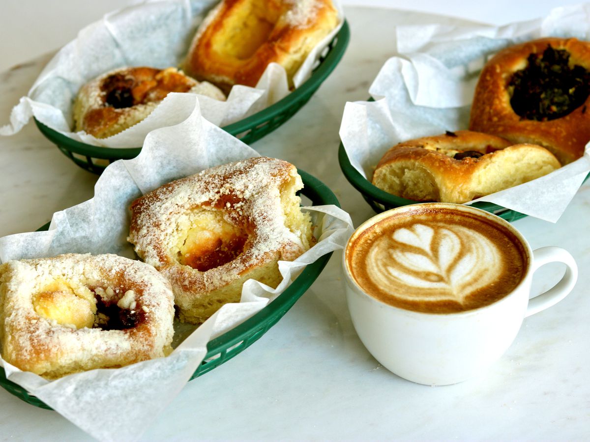 A spread of Czech-Texas pastries, known as kolaches, filled with jam and topped with slices of jalapeno