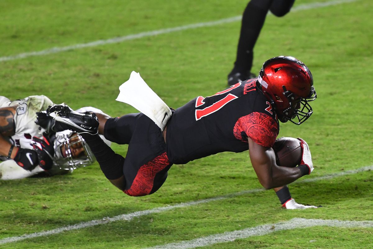 San Diego State Aztecs running back Chance Bell gets past UNLV Rebels defensive back Tre Caine for a touchdown in the fourth quarter of the game at Dignity Health Sports Park.