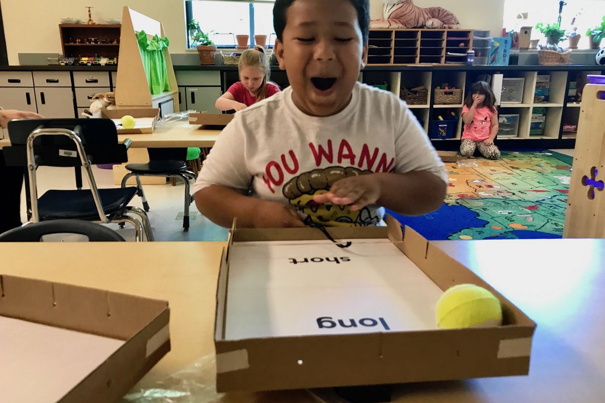 Malachi Ballinger, 6, laughs at how far he has made his “pinball” travel during a science lesson in his kindergarten classroom in Redmond, Oregon.