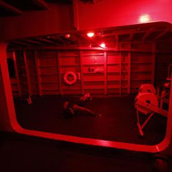 In this picture taken on Monday, Nov. 21, 2016, a U.S. Navy sailor works out in a gym at the U.S.S. Dwight D. Eisenhower aircraft carrier. The carrier is currently deployed in the Persian Gulf, supporting Operation Inherent Resolve, the military operation against Islamic State extremists in Syria and Iraq. 