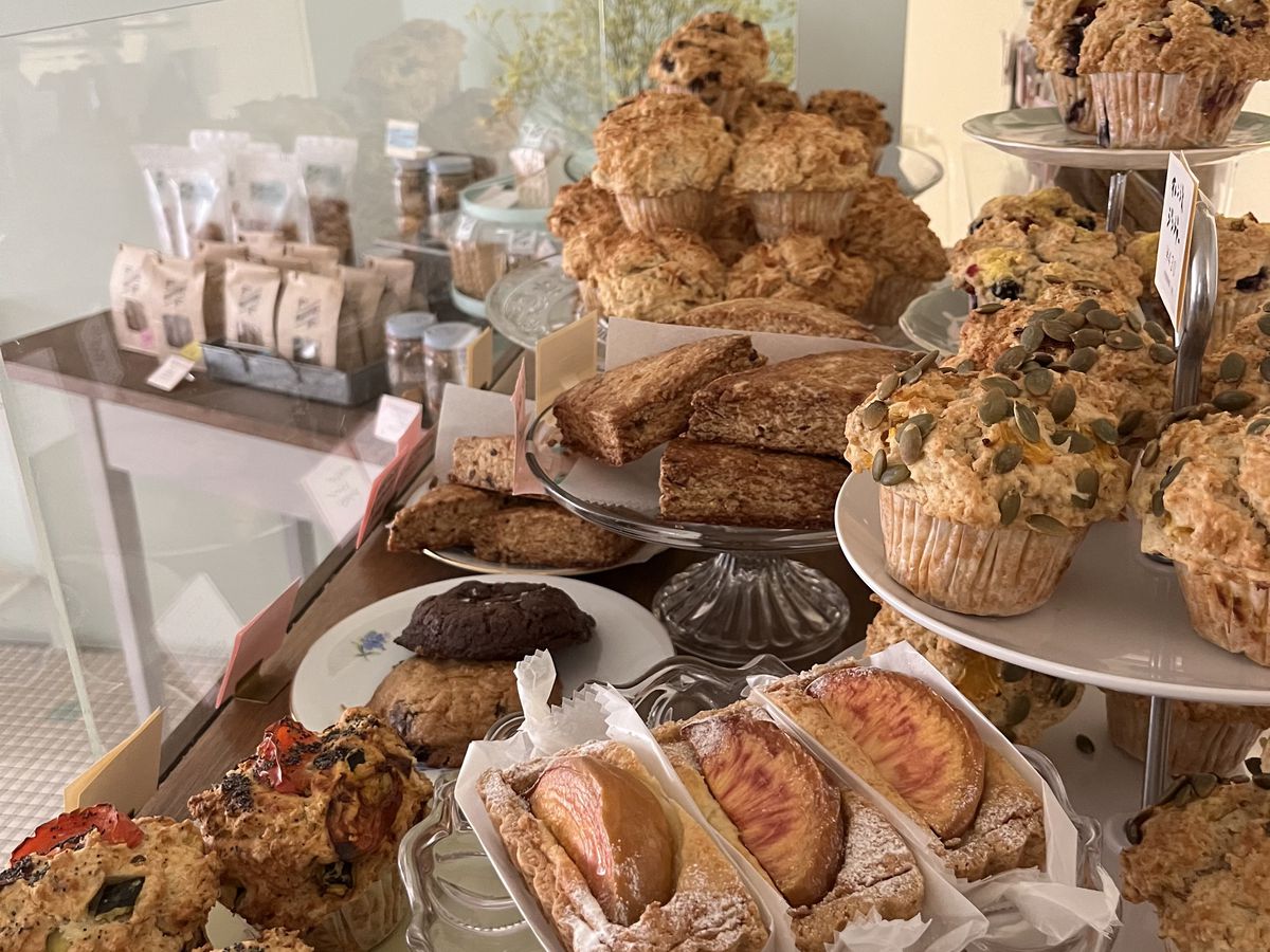 A variety of muffins and other baked goods on display in a bakery.