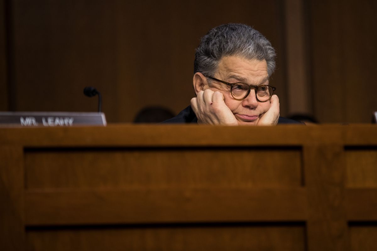 Senator Al Franken listens with his head on his hands while Facebook, Google and Twitter testify before Congress.