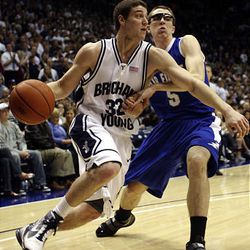 Jimmer Fredette, left, is defended by Mike Fitzgerald of Air Force at the BYU Marriott Center in Provo Saturday. BYU won 91-48.