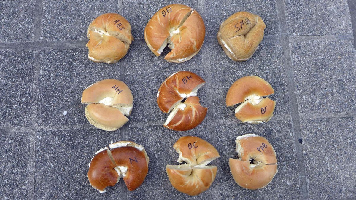9 bagels with cream cheese in rows of three.