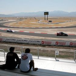 Two race fans watch a car make a turn during a race a Miller Motorsports Park in Tooele Friday July 14, 2006.