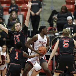 Washington State forward Robert Franks, second from left, spins through the defense of Utah's Parker Van Dyke (5), Justin Bibbins (1) and David Collette (13) as he drives to the basket during the first half of an NCAA college basketball game Saturday, Feb. 17, 2018, in Pullman, Wash. (AP Photo/Ted S. Warren)