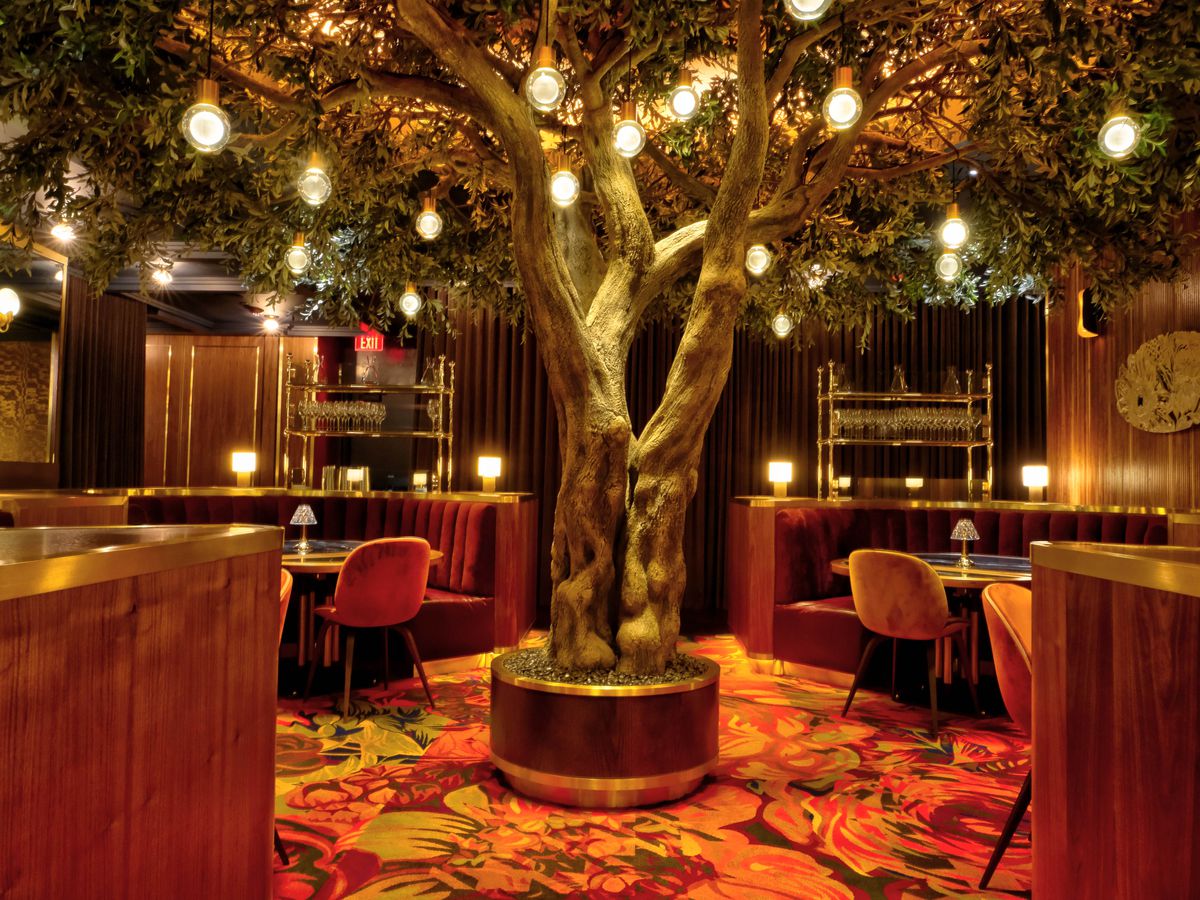 A dining room with a tree at the center.