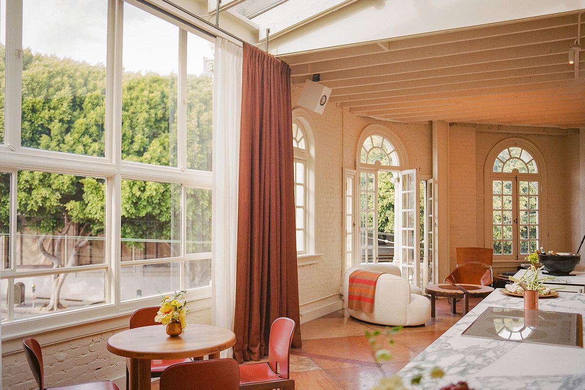 A room with high ceilings and a wall of windows.
