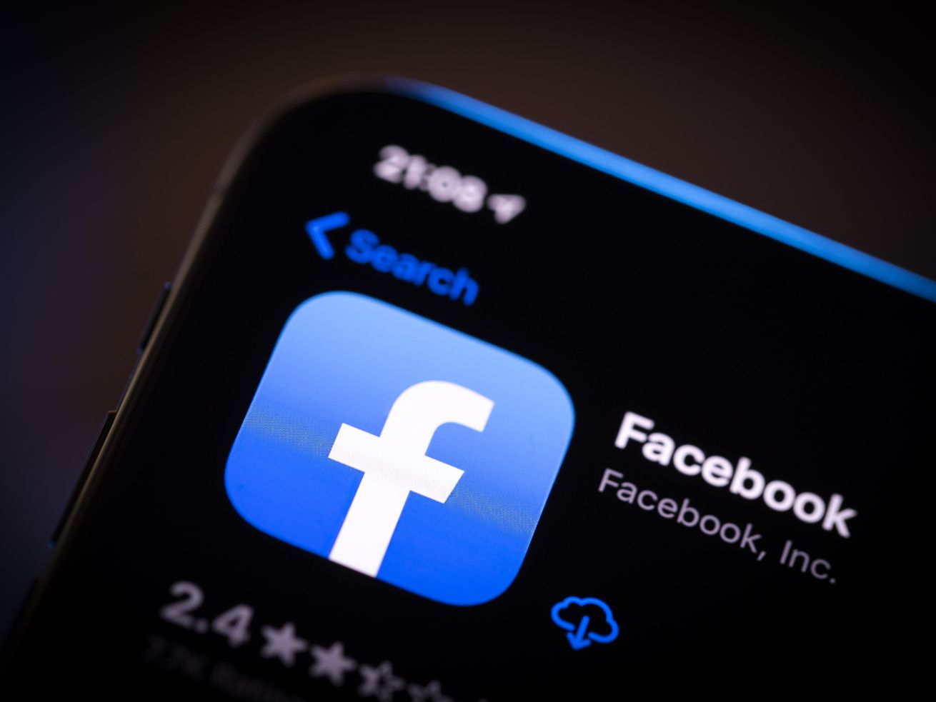 The Facebook app icon is displayed in the Apple App Store on a smartphone screen.