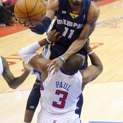 Memphis Grizzlies guard Mike Conley, top, goes to the basket over Los Angeles Clippers guard Chris Paul during the first half of Game 2 of a first-round NBA basketball playoff series, Monday, April 22, 2013, in Los Angeles.  