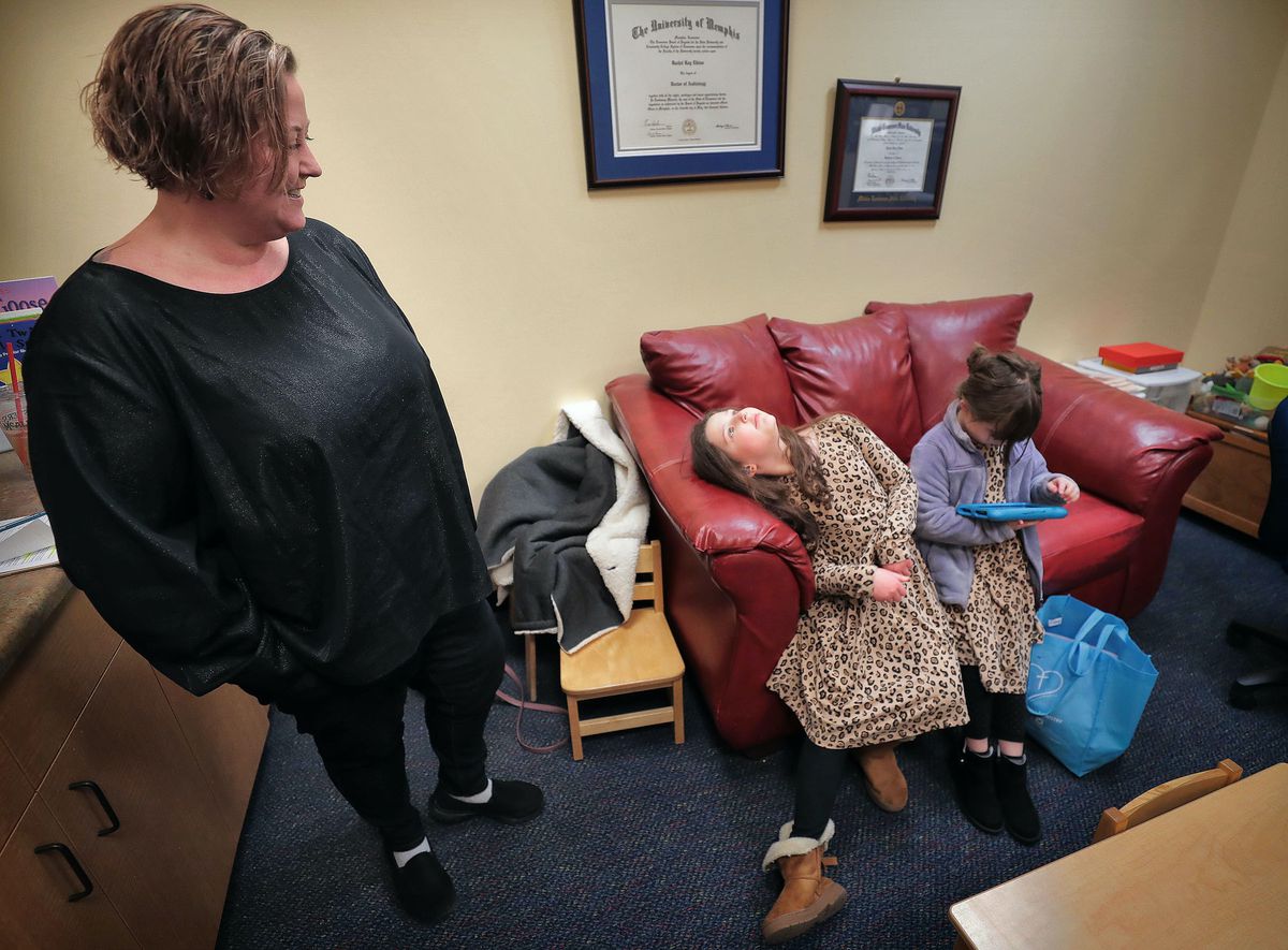 Kris Benassi waits with her daughters Gigi and Josie before the start of Gigi’s hearing test at the Memphis Oral School for the Deaf. The Bartlett family has participated in Tennessee’s voucher program for students with disabilities since its 2017 launch.