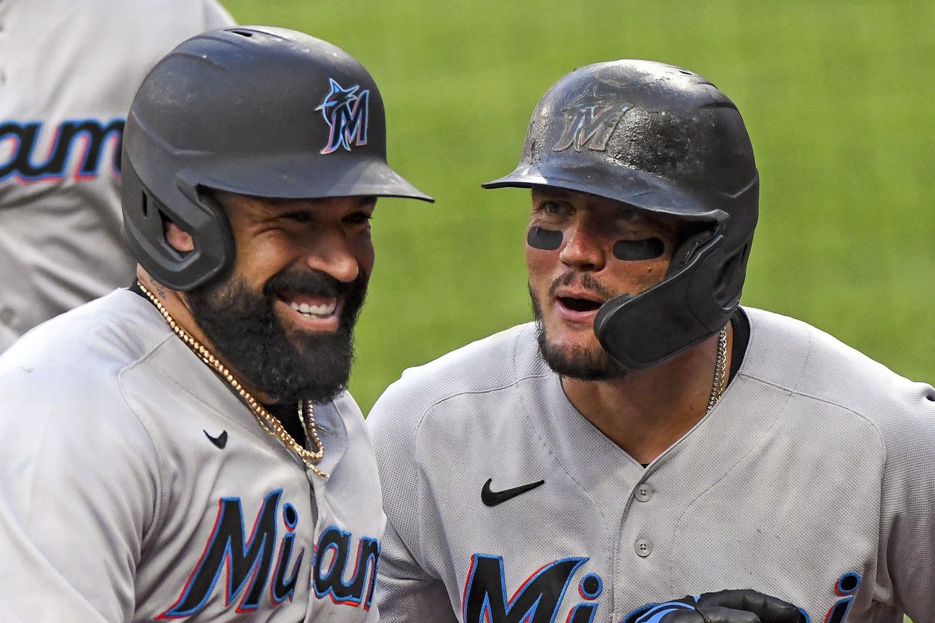 Miami Marlins catcher Sandy Leon (7) is congratulated by shortstop Miguel Rojas (19) after hitting a three run home run in the second inning during the Miami Marlins game versus the Baltimore Orioles