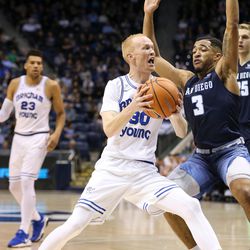 Brigham Young Cougars guard TJ Haws (30) drives against San Diego Toreros guard Olin Carter III (3) at the Marriott Center in Provo on Saturday, Jan. 20, 2018.