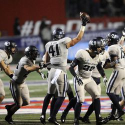 Utah State Aggies linebacker Nick Vigil (41) comes up with the football after an onside kick during the Mountain West football championship game at Bulldog Stadium in Fresno, Calif., on Saturday, Dec. 7, 2013.